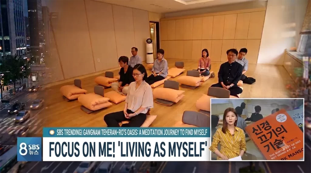 A busy city professional finding peace and meditating at the Teheran-ro Udae Center featured on SBS News